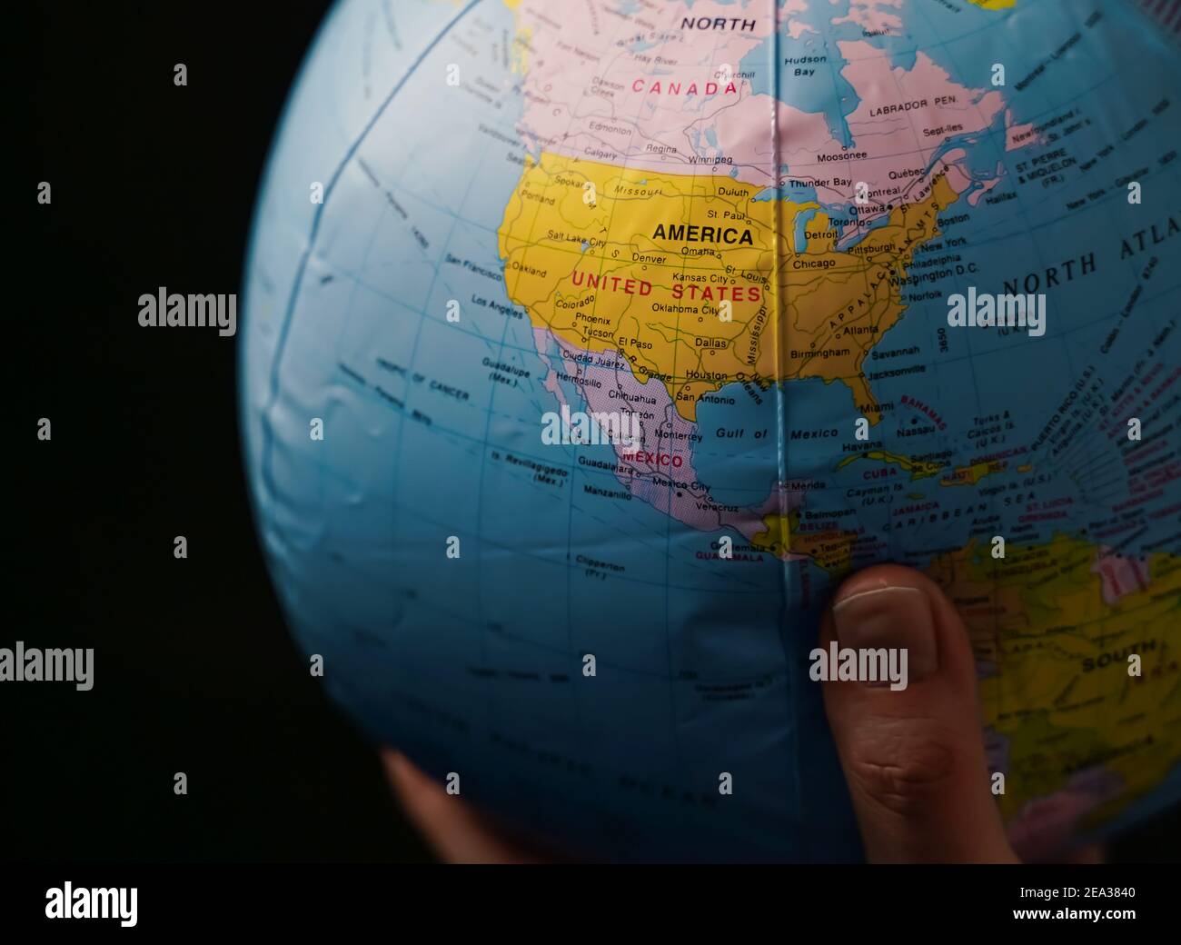 Globe showing the north American continent held in a hand. Stock Photo