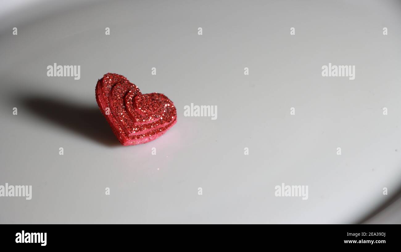 Shiny RED heart isolated on white background with space to right text ...