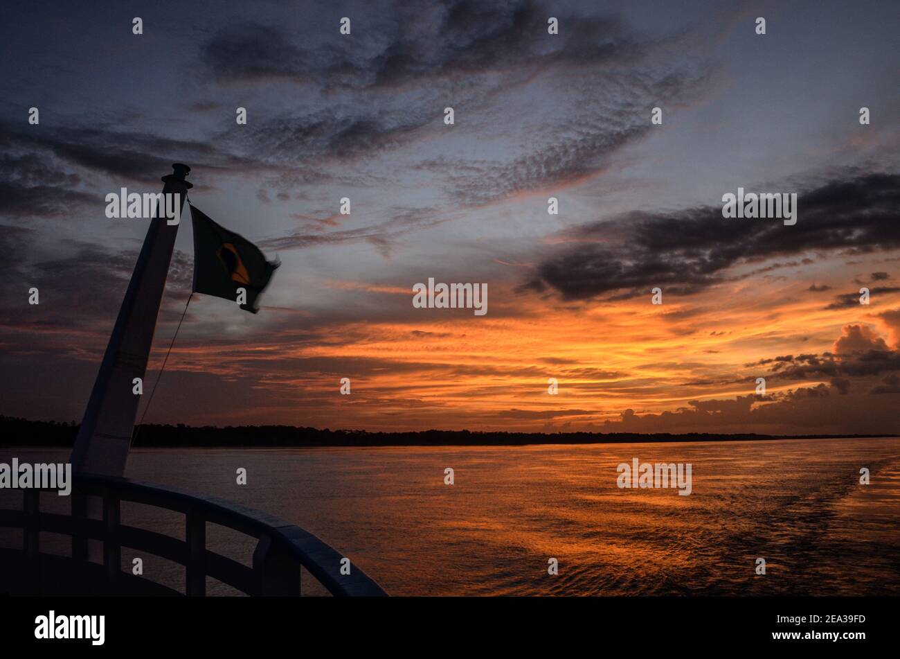 Travelling during the sunset by boat at the giant Amazon River, Brazil. Stock Photo