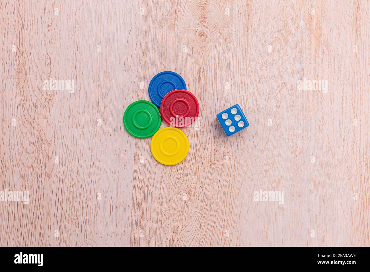 A pile of colorful buttons on a white surface. Buttons colored