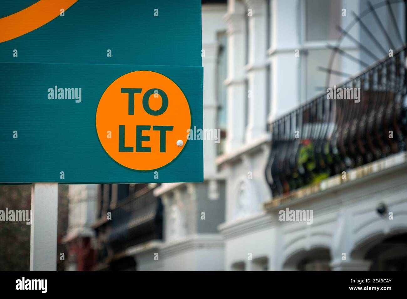 Estate agent 'to let' sign on street of houses Stock Photo