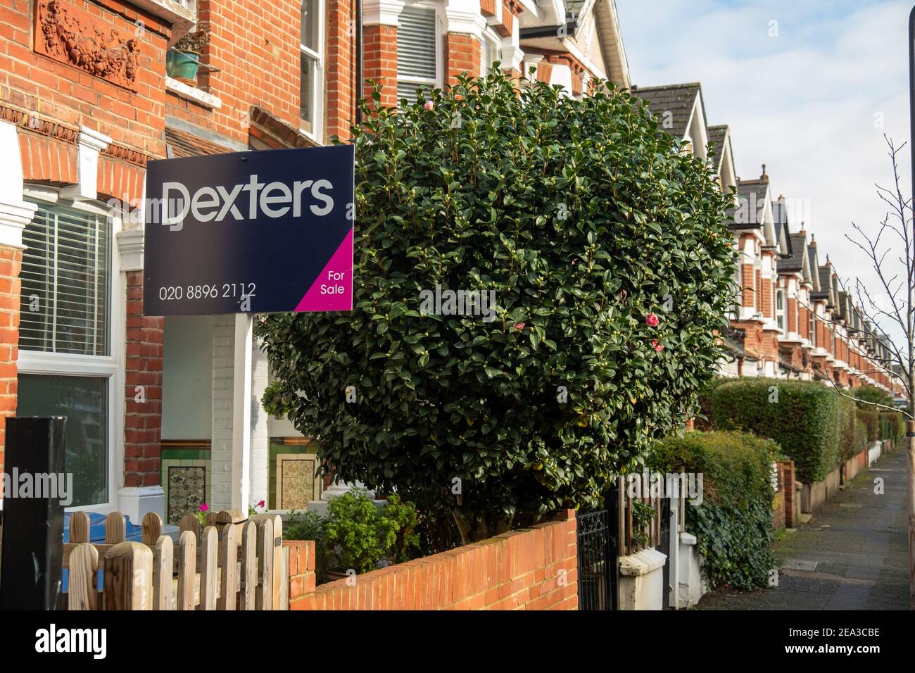 Acton, London Dexters estate agent for sale sign on street of houses