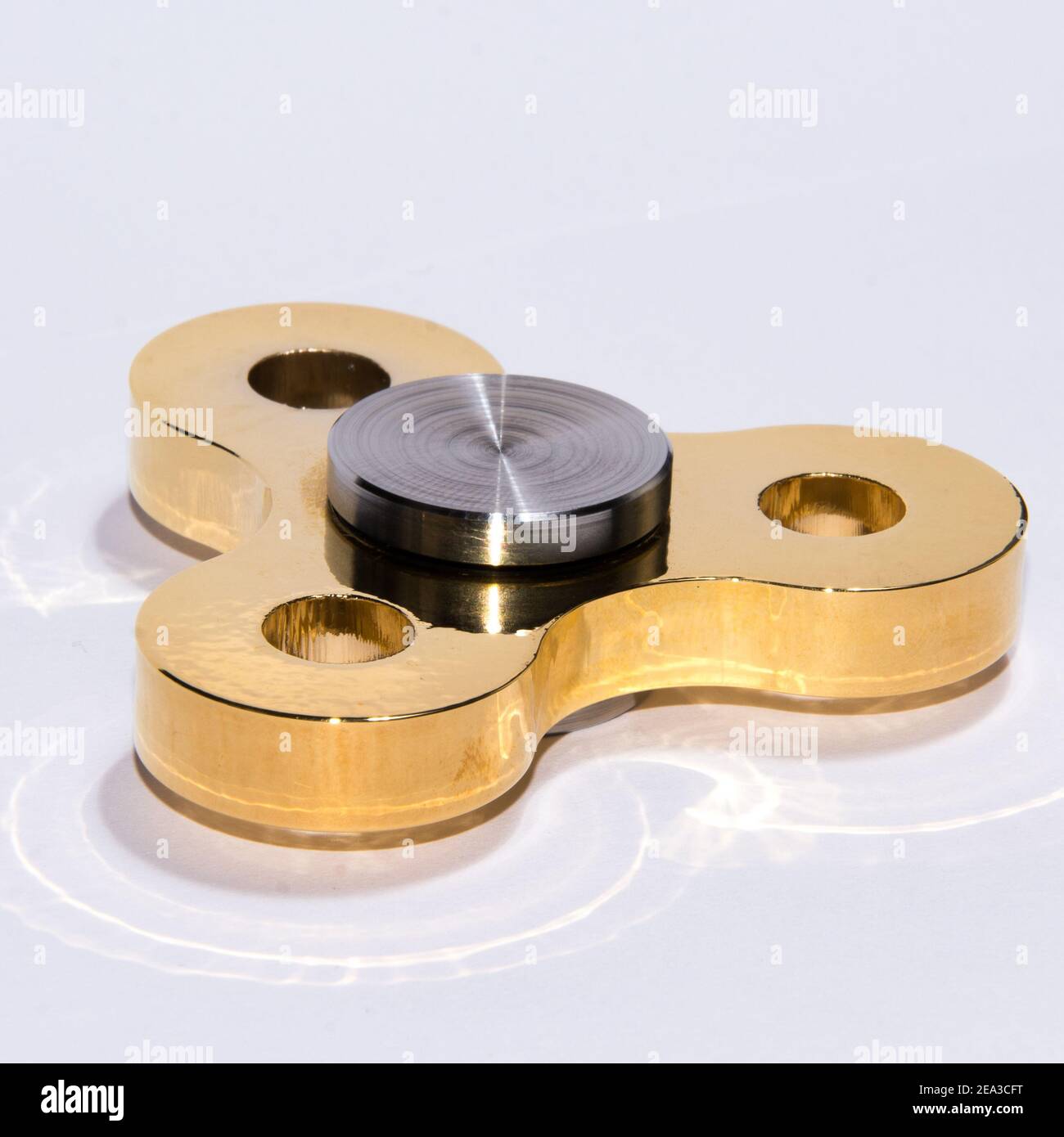 Gold fidget spinner to relax, relieve stress, play  Stock Photo