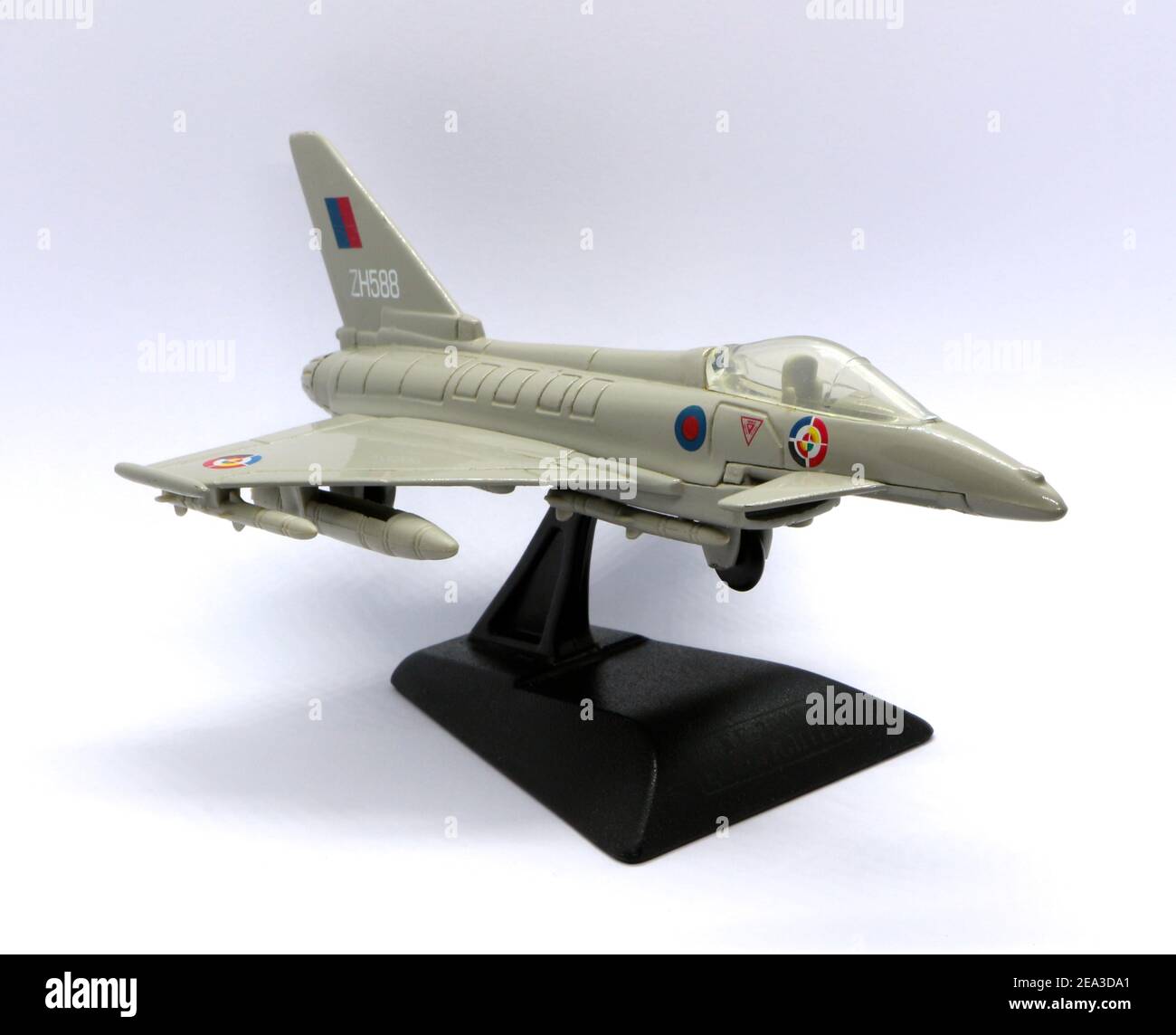 Photo of a Die cast model of a Eurofighter Typhoon multirole fighter on a black plastic stand against a white background Stock Photo