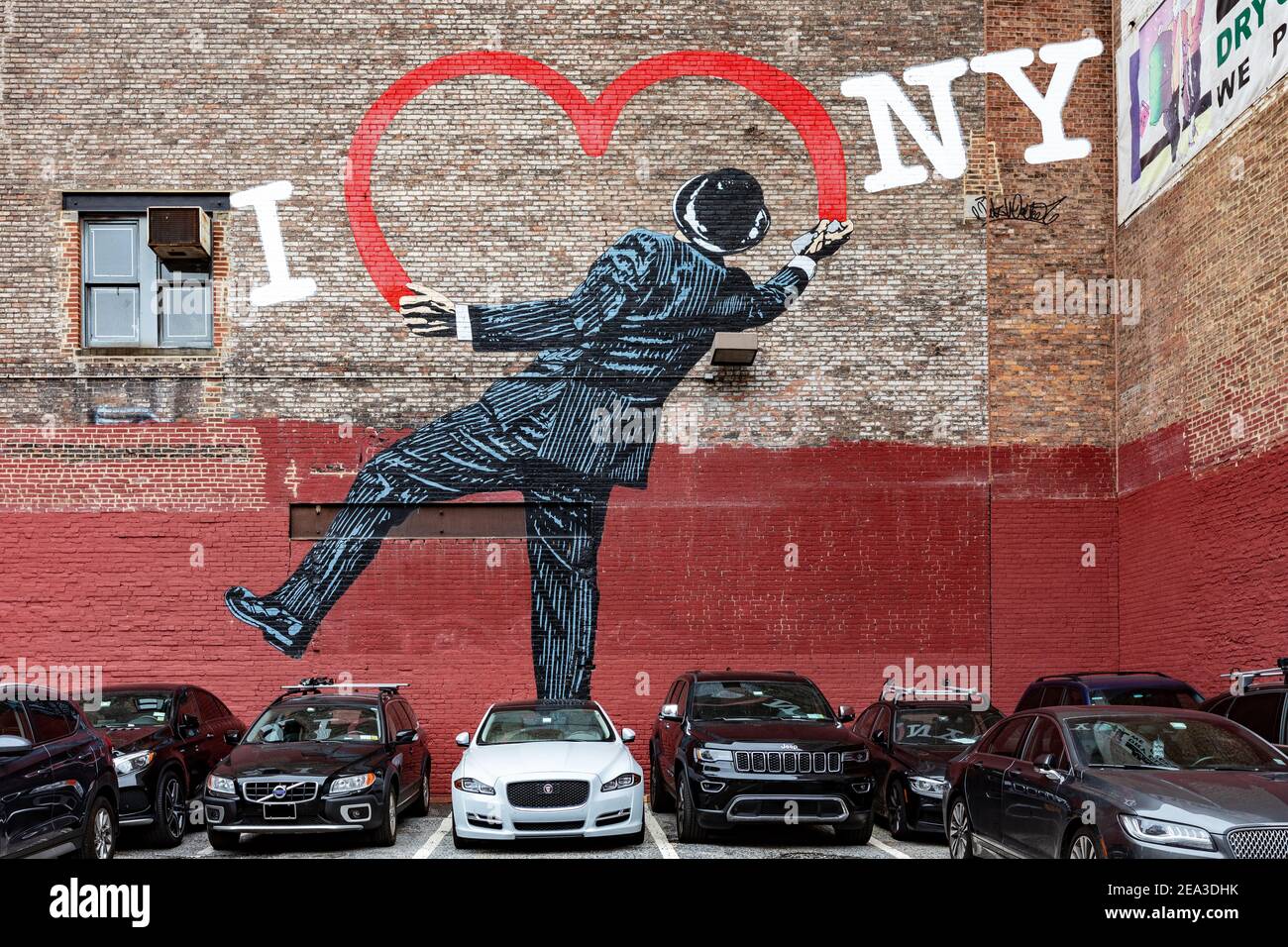 Parking in W17th Street, NYC, with a street wall painting showing a