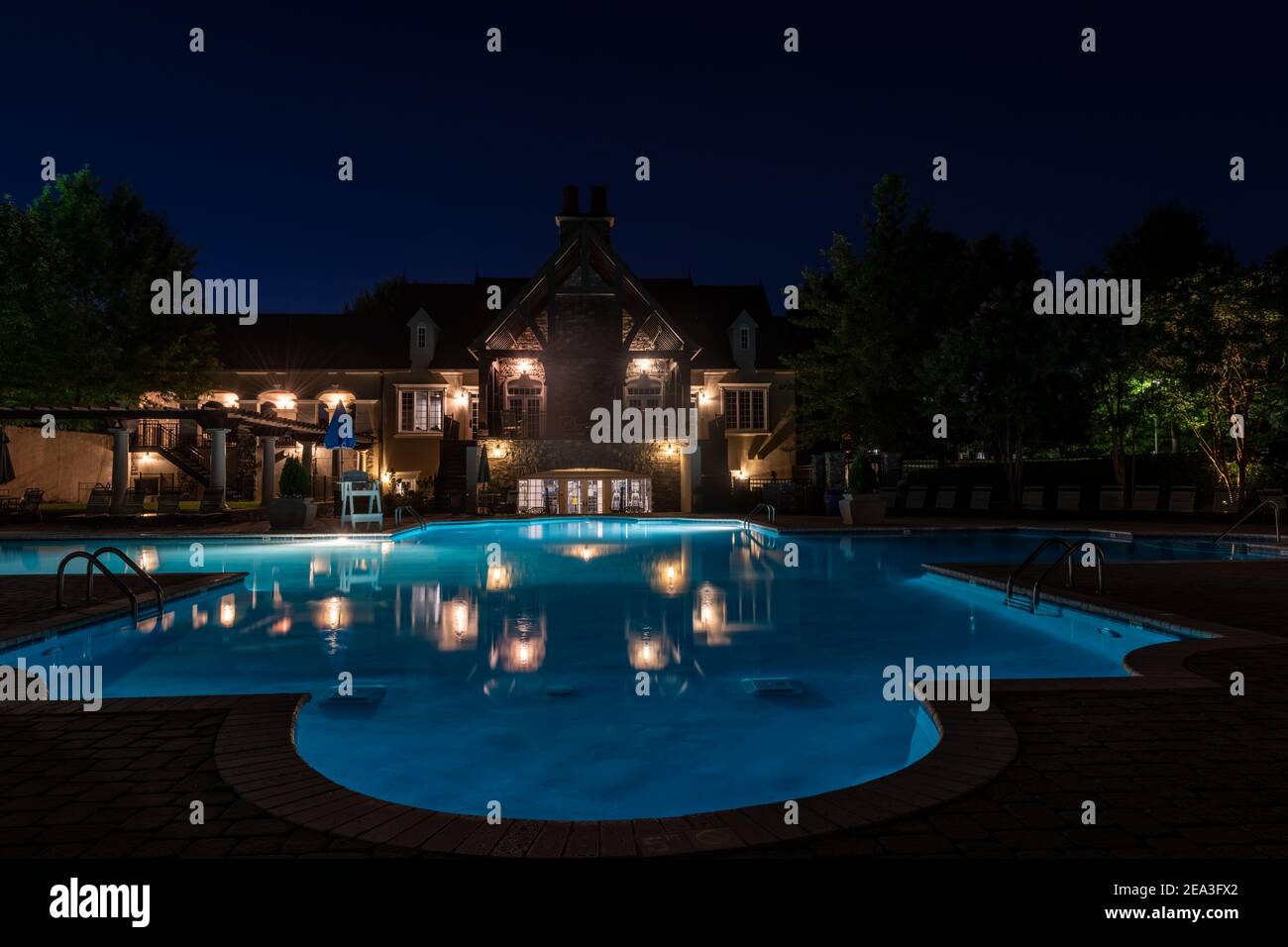 A swimming pool lit up for a night swim. Stock Photo