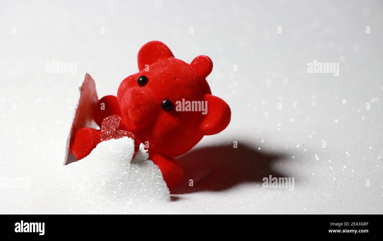 Red teddy bear with shiny red heart erupting from background with space on right side for text. Stock Photo