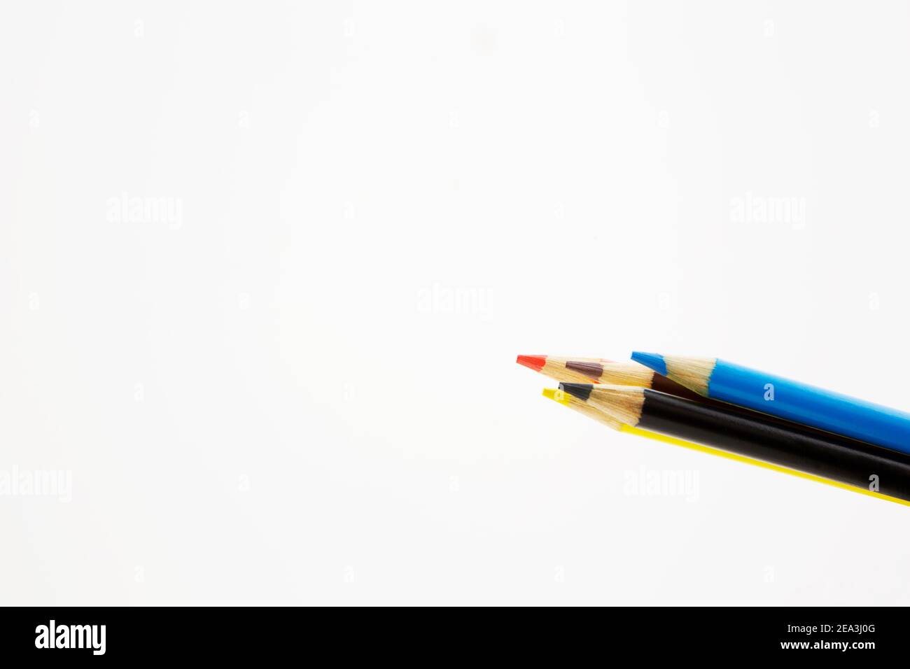 Background with copy space shows assortment of five colored pencils, orange, yellow,  black, blue, brown, symbols of strategic choices Stock Photo