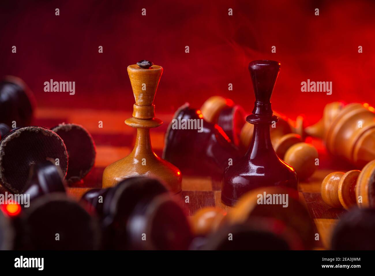 Chess fight, chess pieces on the board, toned in red. Battle fire and