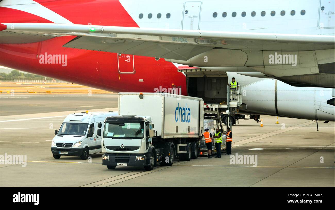 London, England - July 2018: Air freight being loaded into the rear cargo hold of a Qantas Airbus A380. Stock Photo