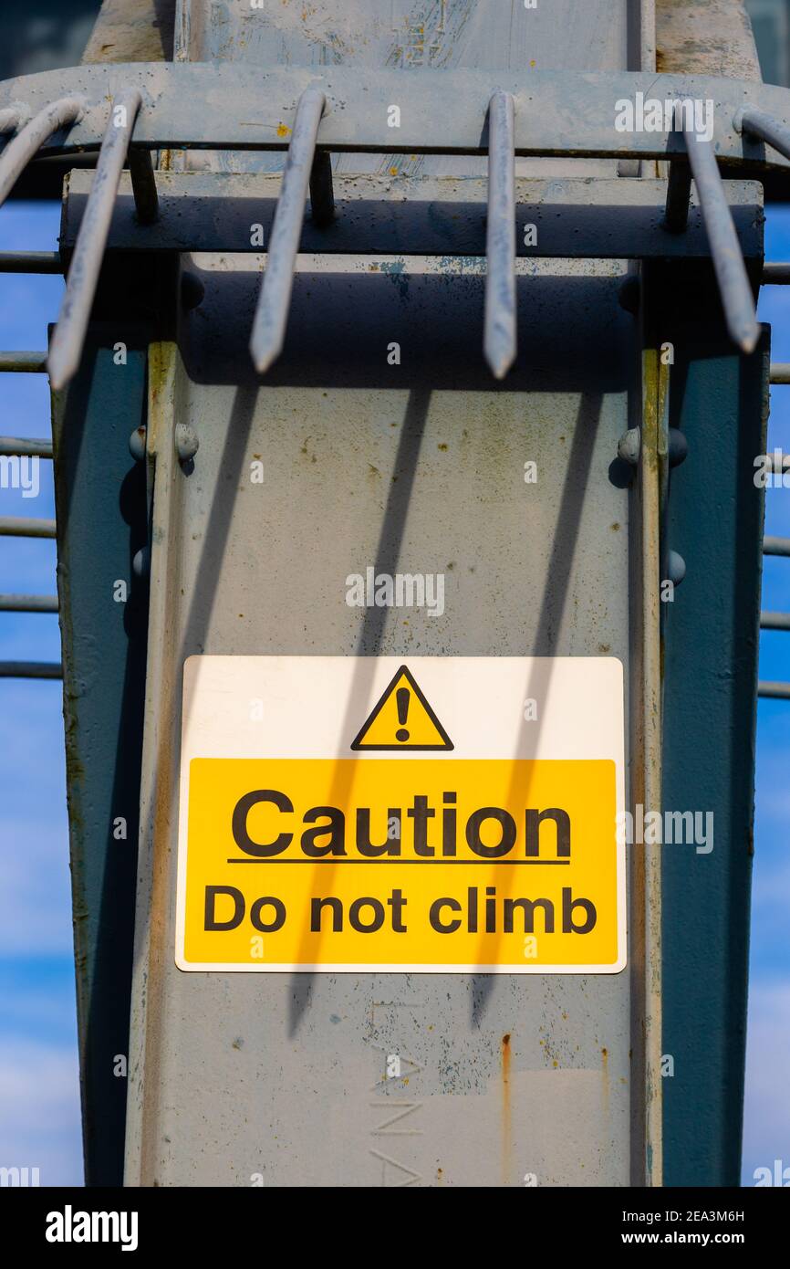 Anti-climb notice protected by large spikes. Stock Photo