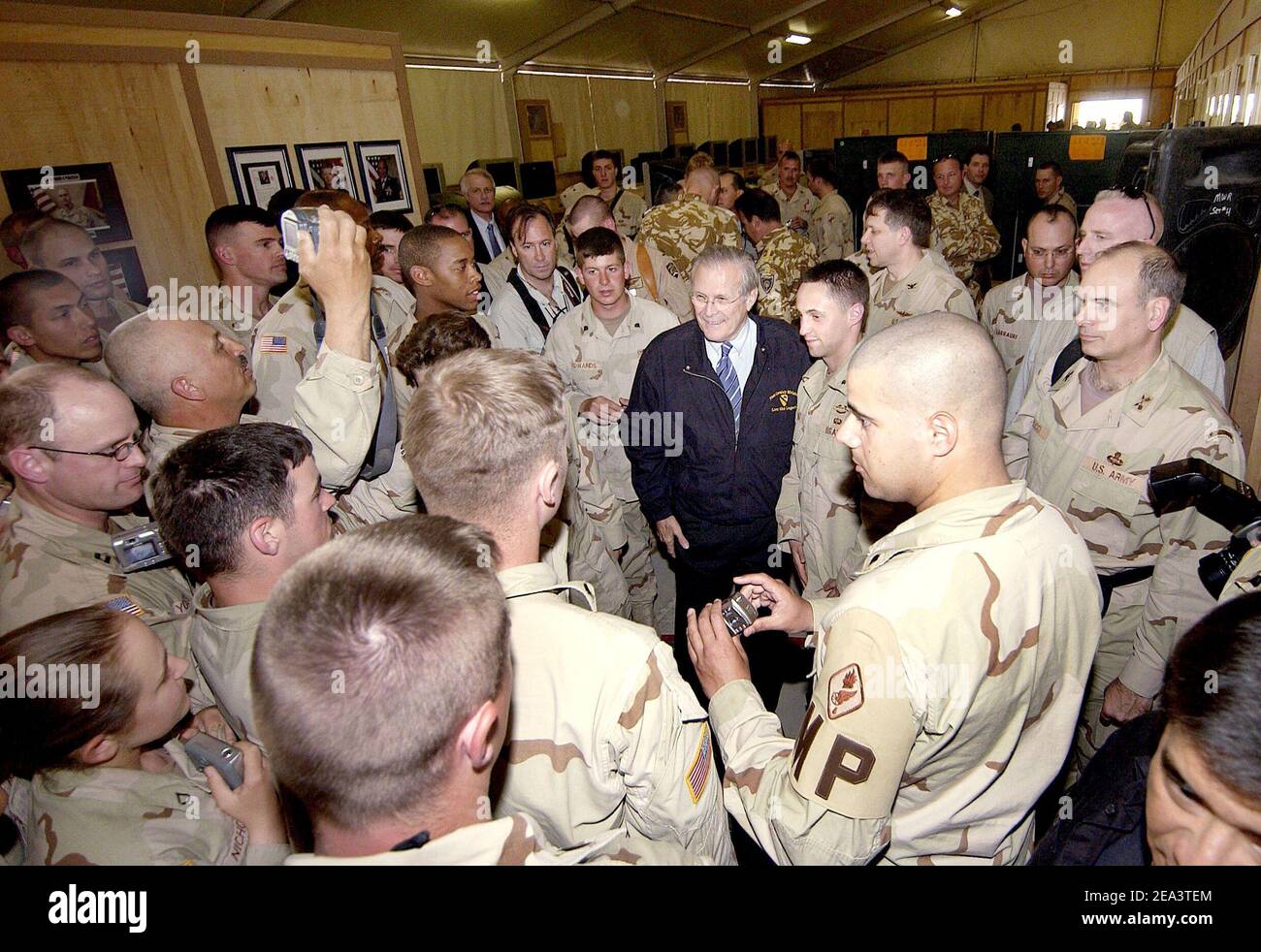 Secretary of Defense Donald H. Rumsfeld is surrounded by troops as he poses with them for photos after a town hall meeting with U.S. and coalition forces in Kandahar, Afghanistan, on April 13, 2005. Rumsfeld is in Afghanistan to visit with U.S. and coalition forces and to meet with key government officials. DoD photo by Tech. Sgt. Cherie A. Thurlby, U.S. Air Force. Photo by DOD/ABACA. Stock Photo