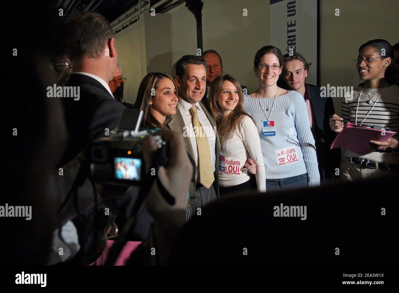 Governing UMP party president Nicolas Sarkozy poses with supporters ...