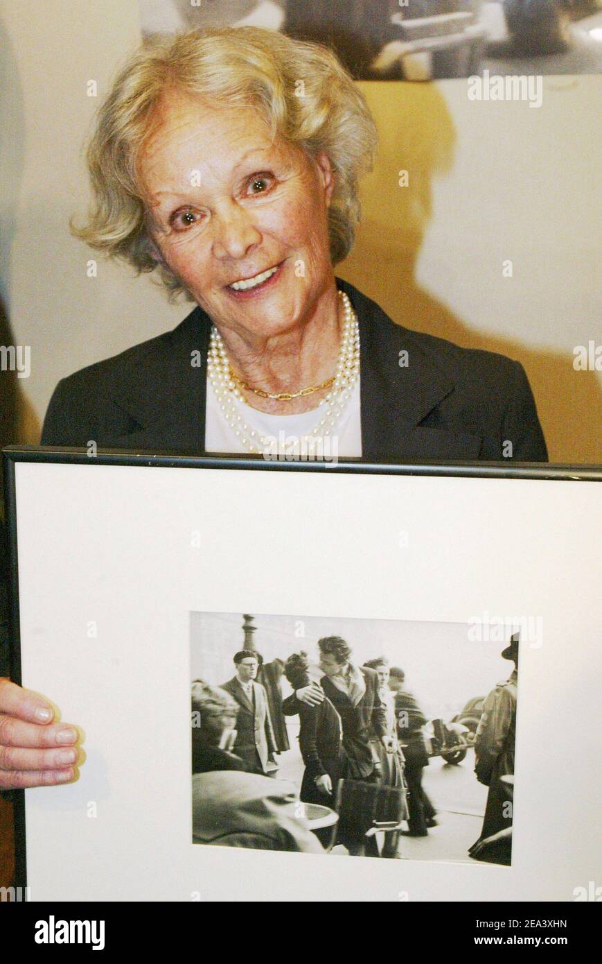 The woman featured in Robert Doisneau's photograph 'The Kiss', Franoise Bornet, poses at the Dassault auction house as an original print of Robert Doisneau's classic photograph 'Baiser de l'Hotel de Ville' (Kiss at City Hall) has been sold 155.000 Euros during an auction of a photography sale in Paris, France, on April 25, 2005. Photo by Mehdi Taamallah/ABACA. Stock Photo