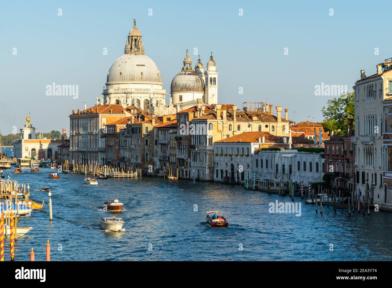Beautiful Venetian cityscape at sunset, with a view on the Grand Canal and the domes of Santa Maria della Salute, Venice, Italy Stock Photo