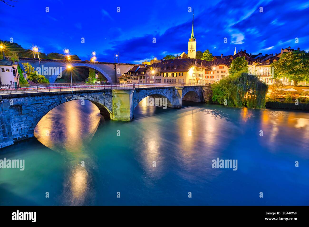 Aare river flows under bridges of Bern old town with view of Nydeggkirche church.Capital of Switzerland, historic center, UNESCO World Heritage Site Stock Photo