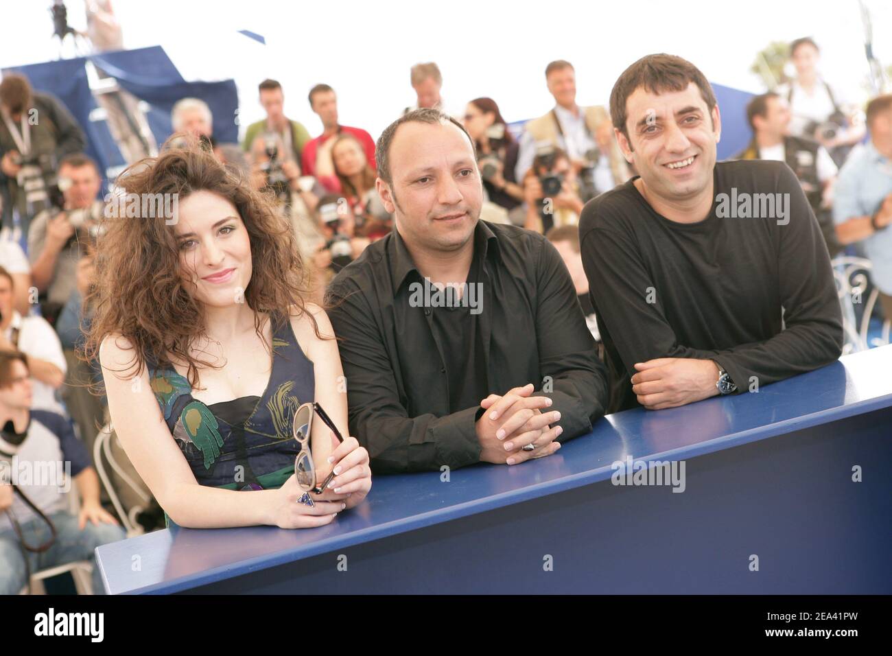 Iraqi director Hiner Saleem, center, Turkish actors Belcim Bigin, right, and Nazmi Kirik, left, poses during a photocall for their film 'Kilometre Zero', during the 58th international Cannes film festival in Cannes, southern France, on May 12, 2005. Photo by Hahn-Nebinger-Klein/ABACA Stock Photo