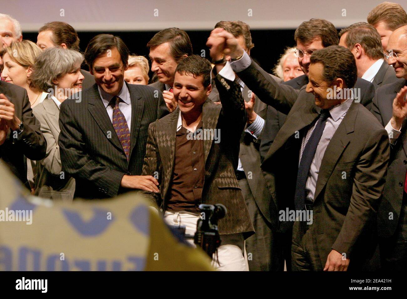 French education Minister Francois Fillon, singer Faudel and Governing UMP party president Nicolas Sarkozy attend a meeting of UMP party for the 'Yes' vote for the upcoming European Constitution referendum vote next May 29, at the Palais des Sports, in Paris, France, on May 12, 2005. Photo by Mousse/ABACA. Stock Photo