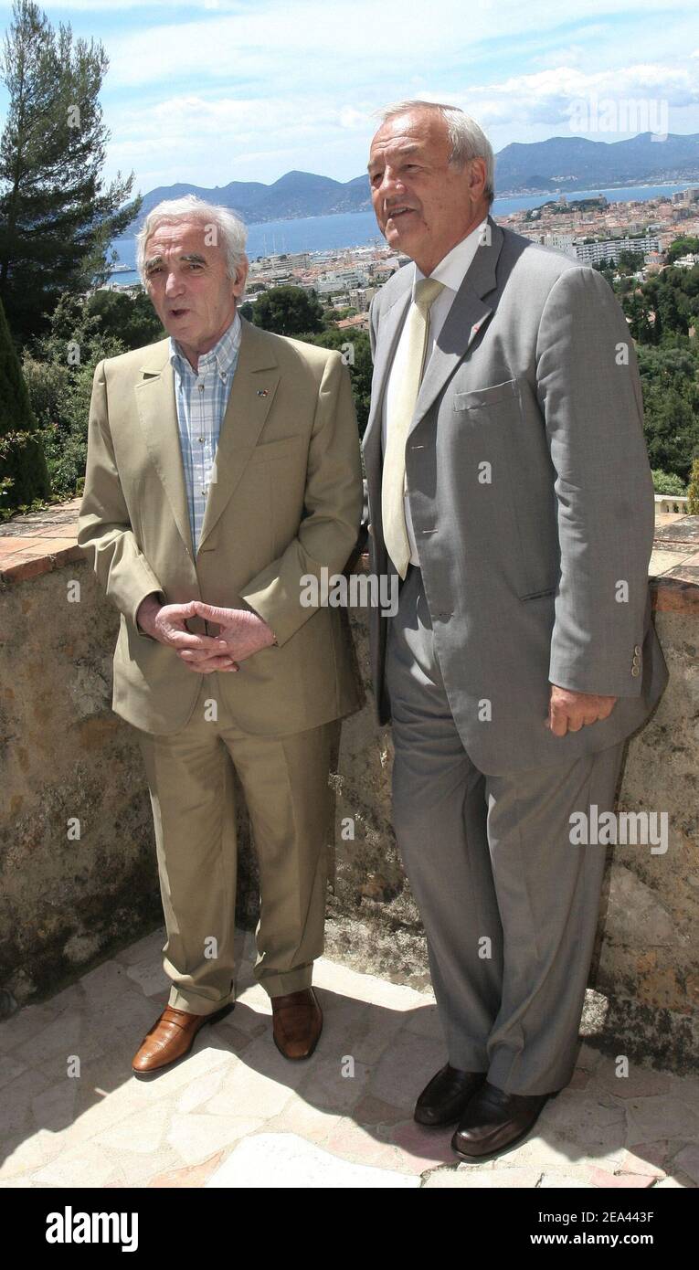French singer Charles Aznavour (L) receives from Cannes' mayor Bernard Brochand, the medal of Citizen of Honor and the palm of the city during a ceremony held at the Villa Domergue in Cannes, France on May 18, 2005. Photo by Benoit Pinguet/ABACA Stock Photo