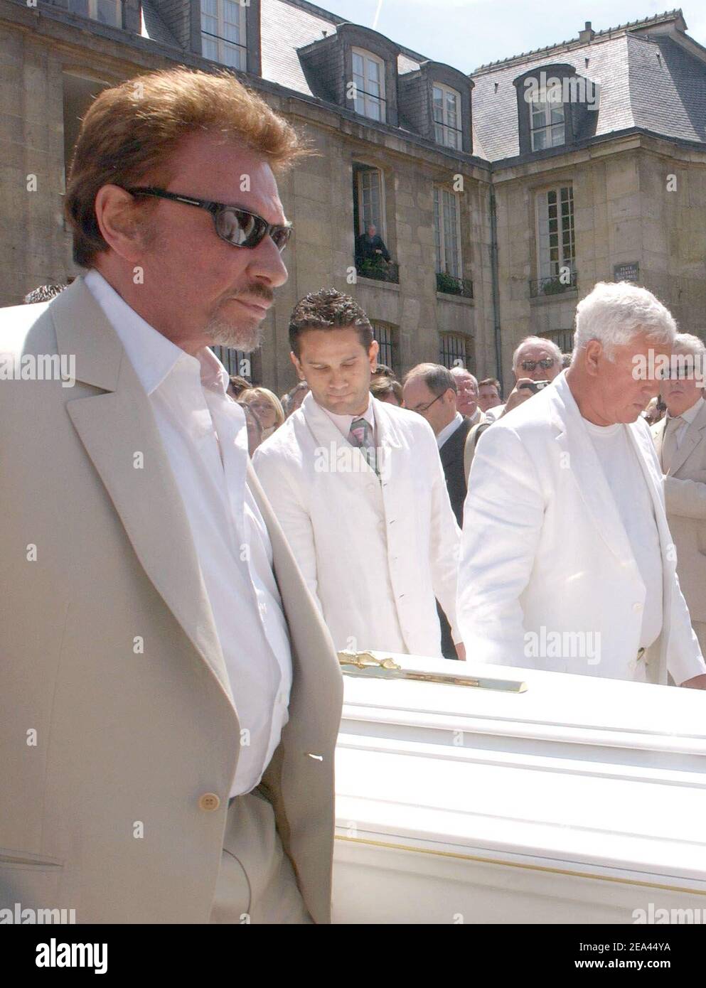 Emotion after Barclay's mass in Paris: one of the six men carrying the coffin is an usurper, a cheater (c), none of the relatives knows him, most of the people thought he was Barclay's second son, but Barclay has a single son... Singer Johnny Hallyday (r), the cheater and Stephane Collaro carry the coffin at St-Germain-des-Pres church in Paris, France, on May 18, 2005, for a mass to pay a tribute to famous French music producer Eddie Barclay who died aged 84 on last Friday. Photo by Gorassini-Mousse/ABACA Stock Photo