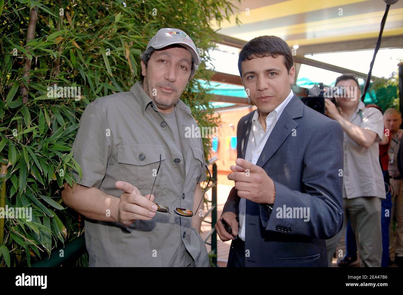 French actor and director Alain Chabat and Rai singer Faudel at the French Open in Roland Garros stadium in Paris, France on May 28, 2005. Photo by Gorassini-Zabulon/ABACA Stock Photo