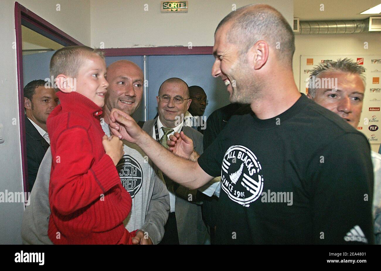 French national goalkeeper Fabien Barthez (L) with a sick child in his ...