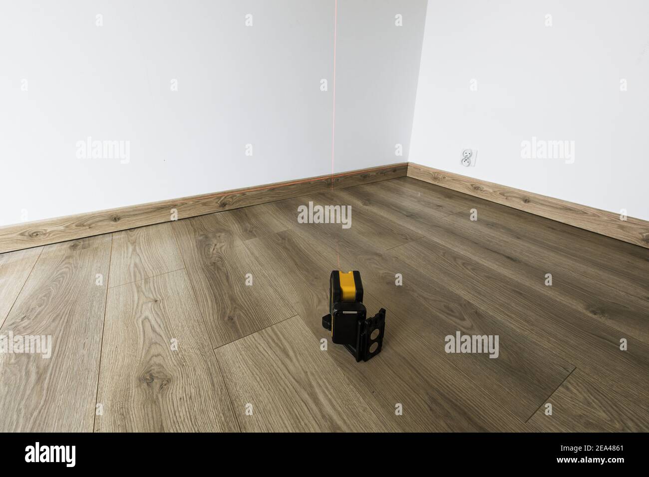 Electronic laser shows level and plumb on the wall Stock Photo