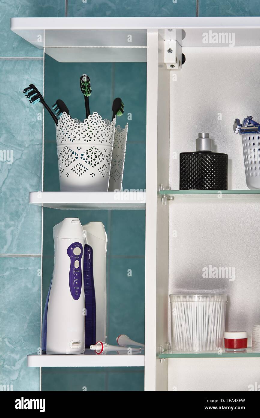 Oral care products and other hygiene items on shelf in bathroom