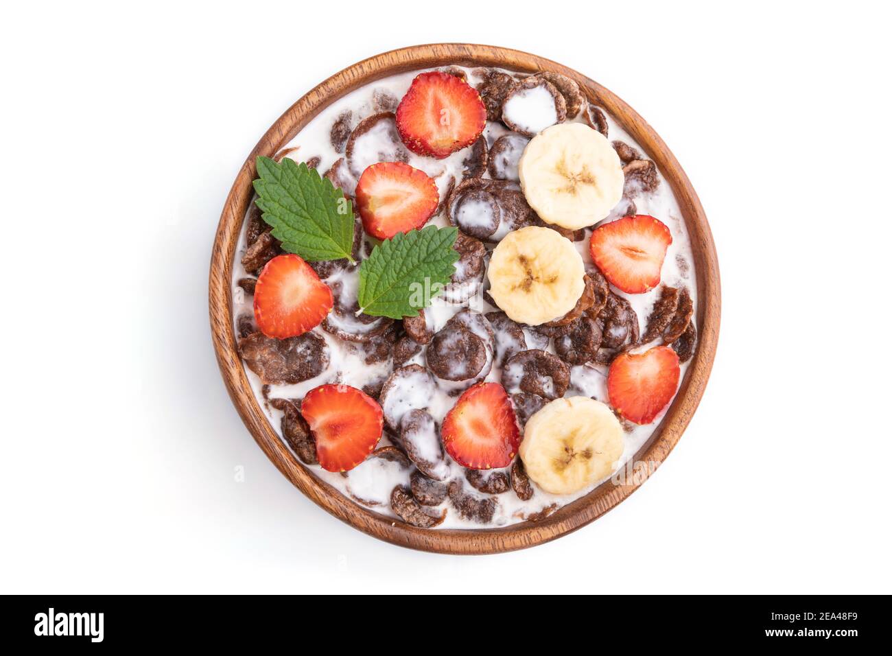Chocolate cornflakes with milk and strawberry in wooden bowl isolated on white background. Top view, flat lay, close up. Stock Photo