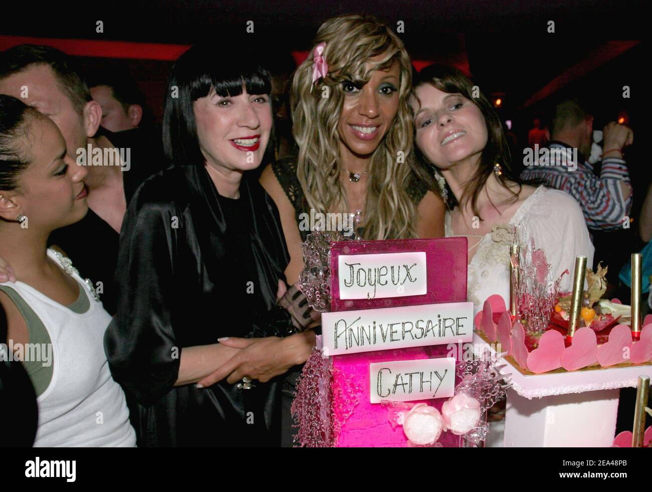 Night club owner Cathy Guetta poses with (L-R) singer Amel Bent, fashion designers Chantal Thomass and Lolita Lempicka as she celebrates her birthday at 'La Suite' in Paris, France, on June 2, 2005. Among the guests, U.S. actor Don Johnson, Florent Pagny, Noemie Lenoir, Emma de Caunes, Bernard Montiel, Chantal Thomass, Lolita Lempicka, Faudel, Yamina Benguigui, Henri Leconte, Severine Ferrer, Emilie Dequenne, Amel Bent. Photo by Benoit Pinguet/ABACA. Stock Photo
