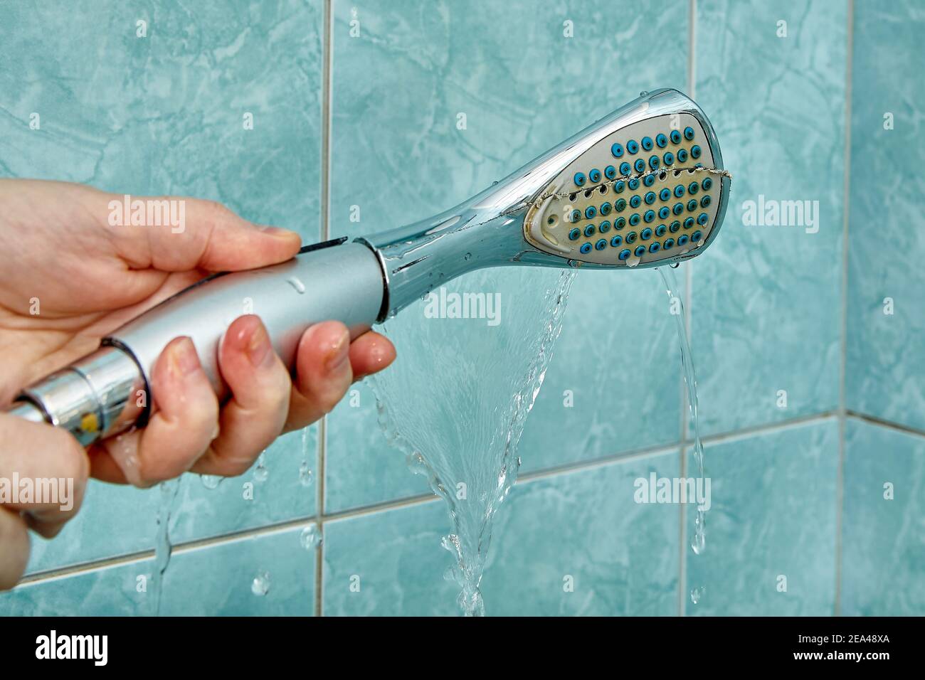 Replacing an old broken shower head in the bathroom Stock Photo Alamy