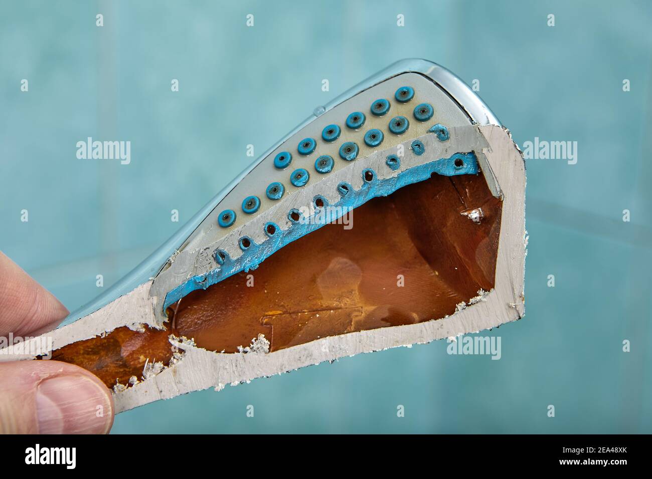 Cutaway old shower head reveals rust inside Stock Photo Alamy
