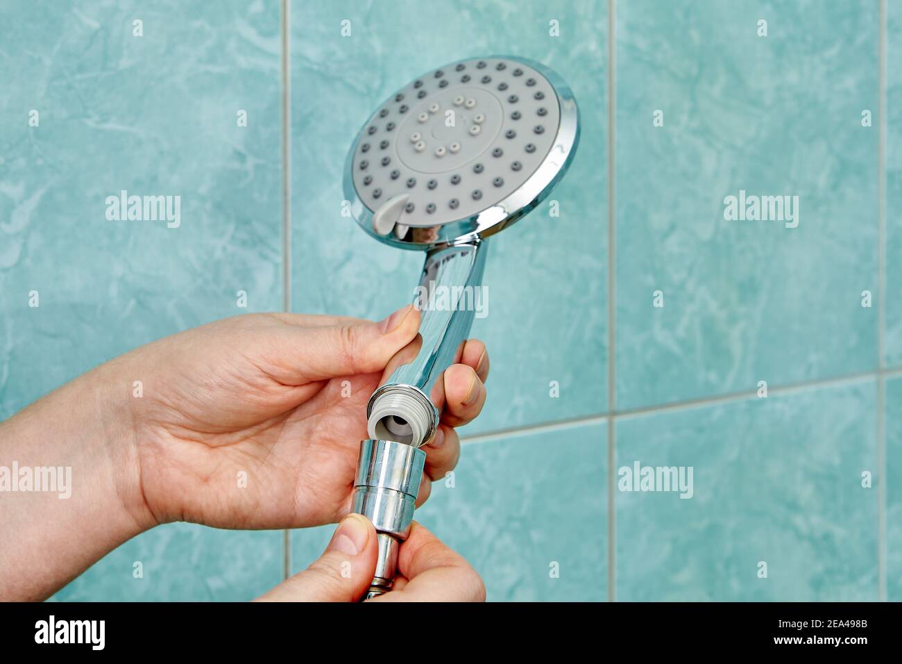 Fitting new flat shower head to hose in bathroom Stock Photo Alamy