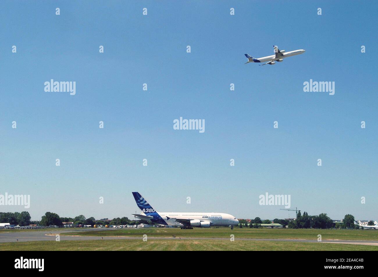 The new super-jumbo Airbus A380 lands at Le Bourget airport during its flying display at Le Bourget Paris Air Show as a A340 flies over, June 14, 2005. Boeing overtook Airbus in the race for aircraft orders, grabbing the lion's share of their combined 10.4 billion dollars (8.6 billion euros) in deals announced in the first two days of the Paris Air Show. Photo by Ammar Abd Rabbo/ABACA Stock Photo