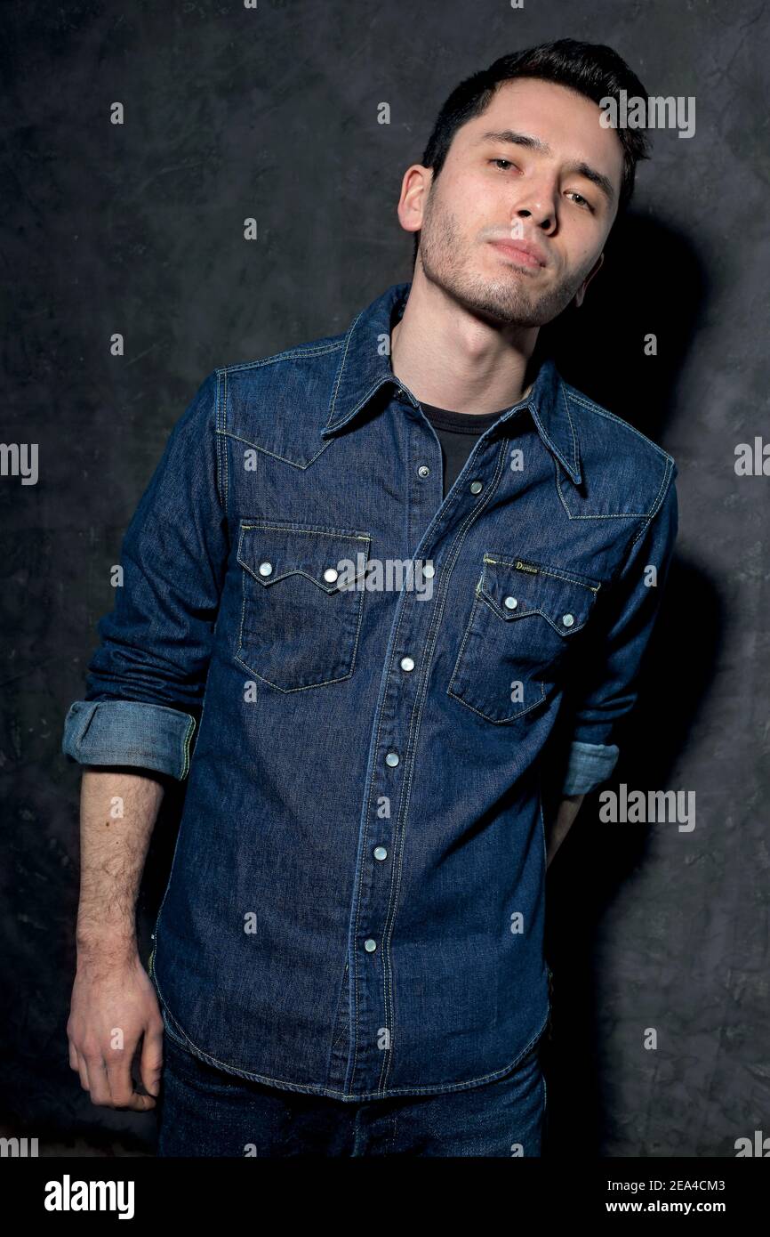 Young  stylish man dressed in blue denim shirt. Stock Photo