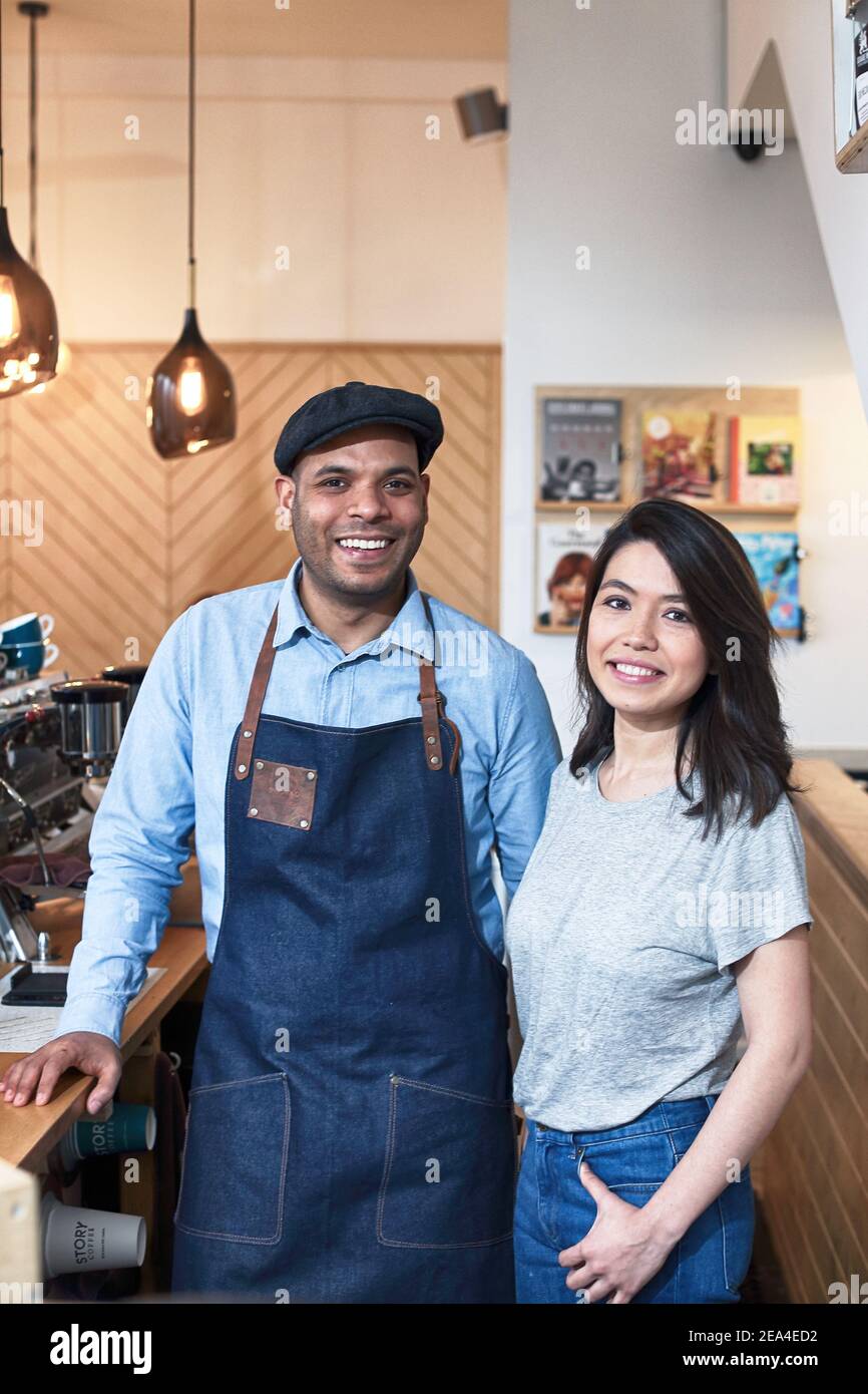 Coffee Business Concept portrait of barista in apron with his partner