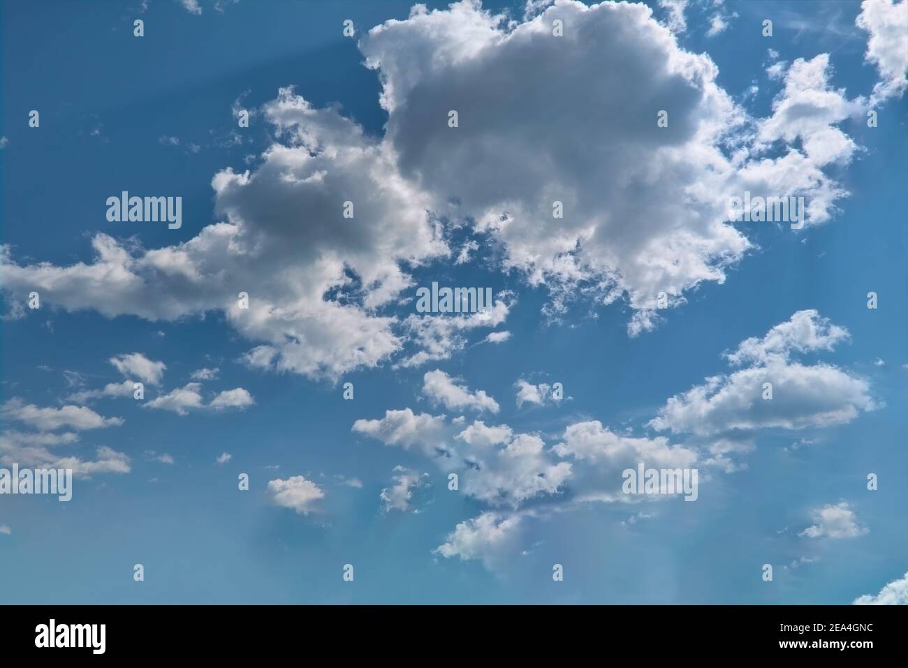 White fluffy clouds in the blue sky. Blue summer sky with white cumulus ...