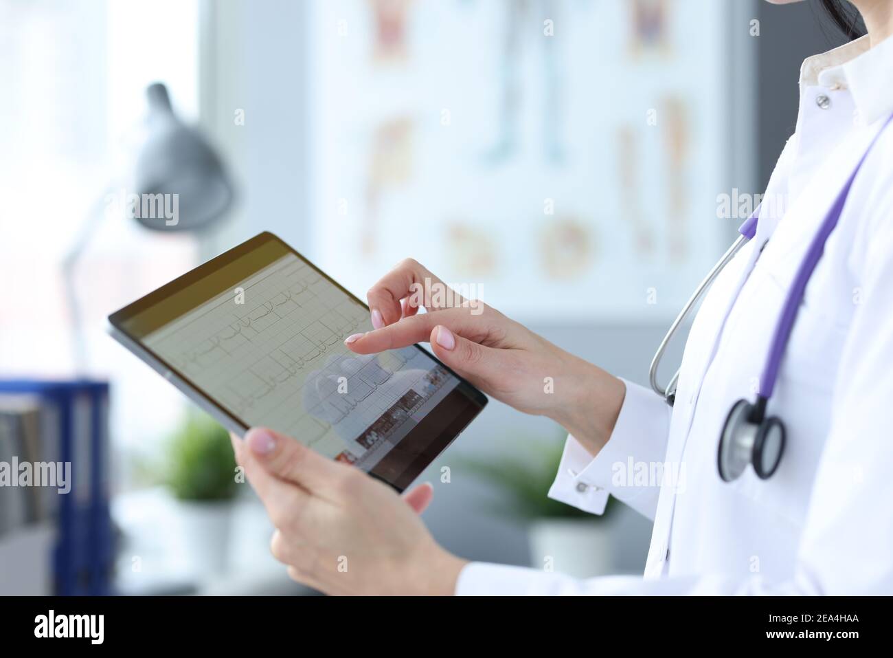 Doctor is holding tablet with heart cardiogram Stock Photo - Alamy
