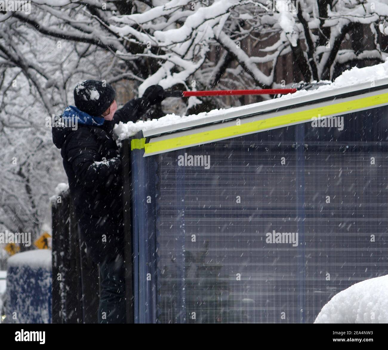 New York, New York, USA. 7th Feb, 2021. The second major snow storm of the season fell on New York City today, leaving over 4 inches of snow. A worker clears the snow off the outdoor dining area of a restaurant on Manhattan's Upper West Side. Credit: Debra L. Rothenberg/ZUMA Wire/Alamy Live News Stock Photo