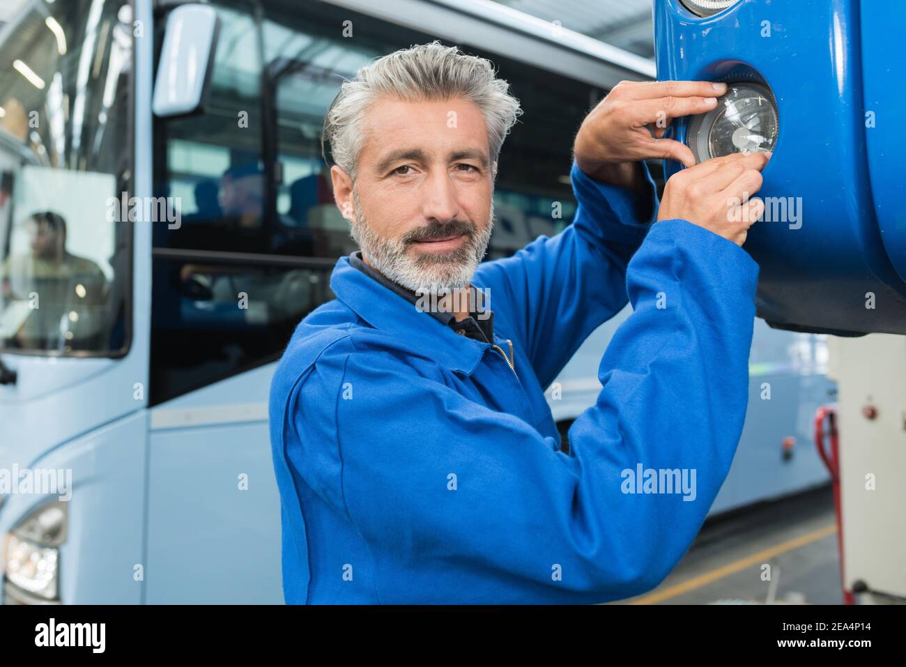a man repairing a bus Stock Photo