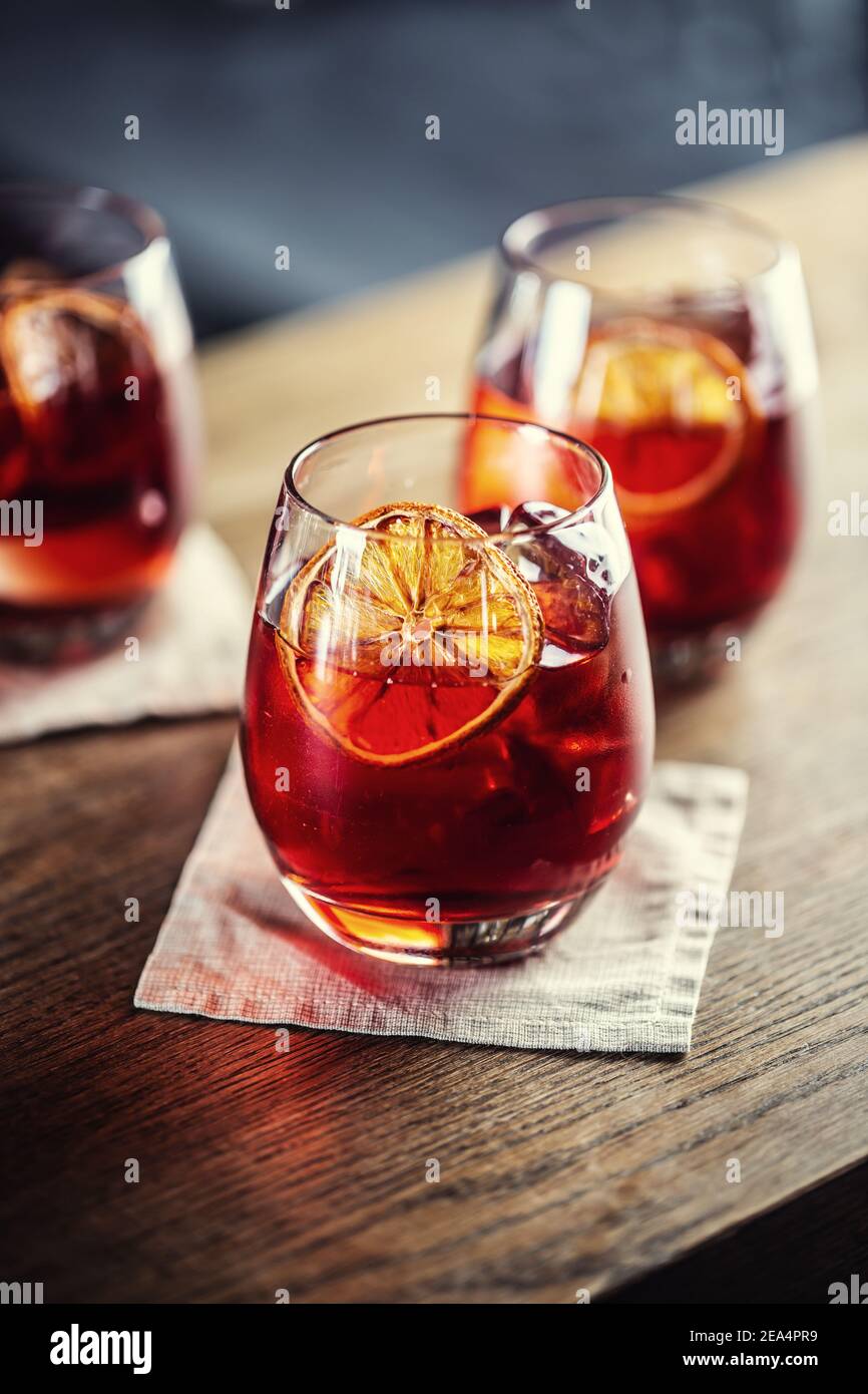 Negroni classic cocktail gin short vermouth, red bitter liqueur and dried orange garnish Stock Photo - Alamy