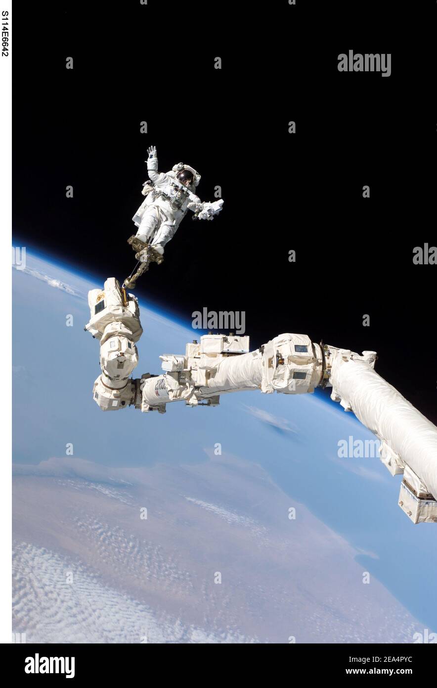 Astronaut Stephen K. Robinson, STS-114 mission specialist, anchored to a foot restraint on the International Space Station Canadarm2, participates in the missions third session of extravehicular activity (EVA) on August 3, 2005. The blackness of space and Earths horizon form the backdrop for the image. Photo by NASA/ABACAPRESS.COM Stock Photo