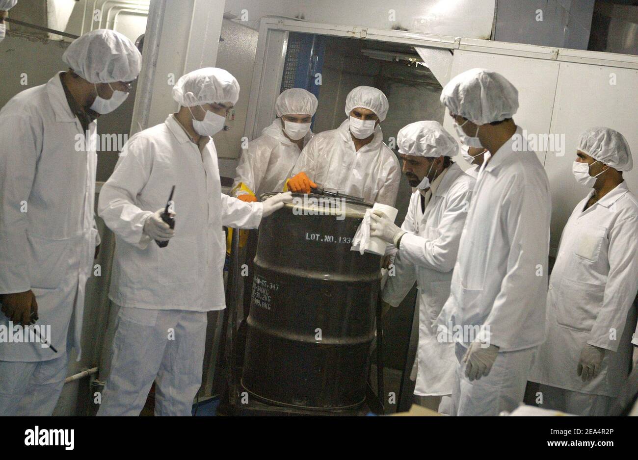 Iranian technicians remove a container of radioactive uranium, 'yellow cake', sealed by the International Atomic Energy Agency, to be used at the Isfahan Uranium Conversion Facilities (UCF), 420 kms south of Tehran, Iran, on August 8, 2005. Iran looked set to resume sensitive nuclear fuel work imminently after the arrival of UN inspectors at a uranium conversion plant. Photo by ABACAPRESS.COM. Stock Photo