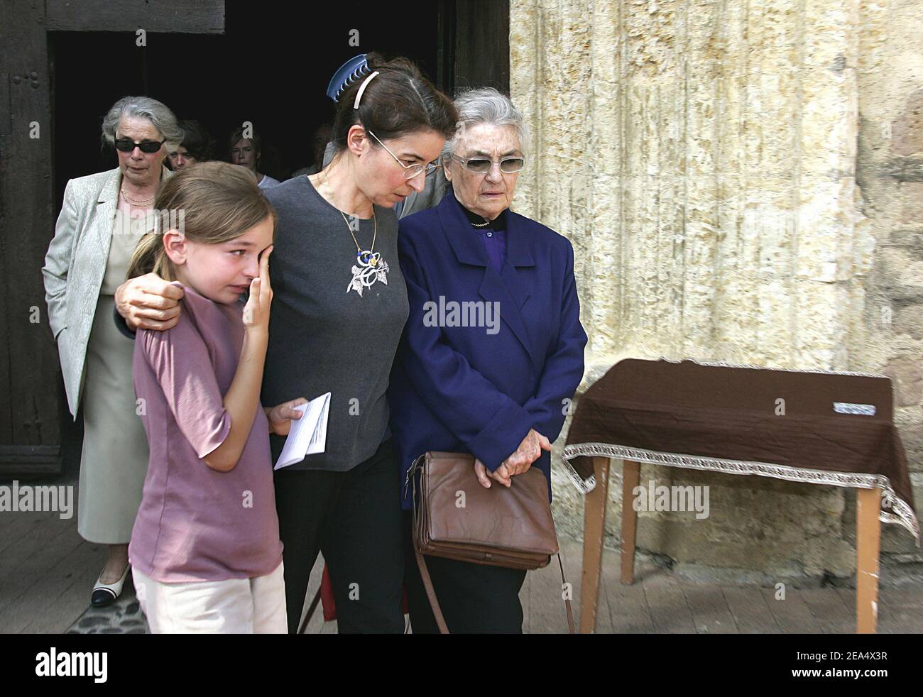Jacques Dufilho's wife Colette (in blue), daughter Emmanuelle and granddaughter Agnes leave the funeral of the late French actor held at the cathedral of Mirande, southwestern France, on August 31, 2005. Dufilho died on August 28 aged 91. Photo by Patrick Bernard/ABACAPRESS.COM. Stock Photo