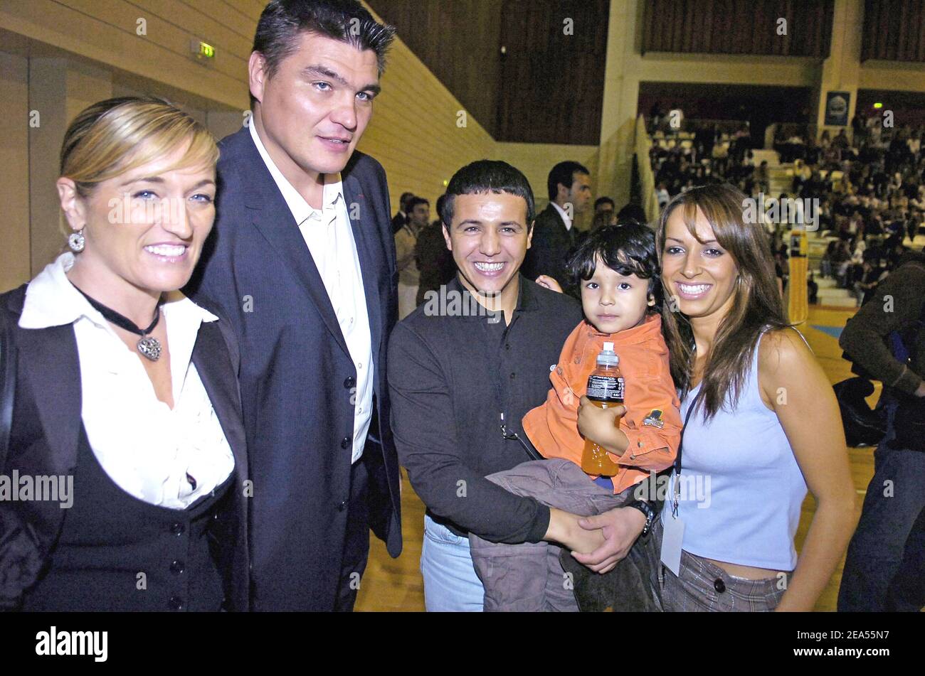 French former olympic champion judoka David Douillet and his wife Valerie pose with French singer Faudel with his wife Anissa and his son Anzy at French basket player Tony Parker of San Antonio Spurs and Powerade show in Issy-les-Moulineaux, near Paris, in France, on September 27, 2005. Photo by Nicolas Gouhier /CAMELEON/ABACAPRESS.COM Stock Photo