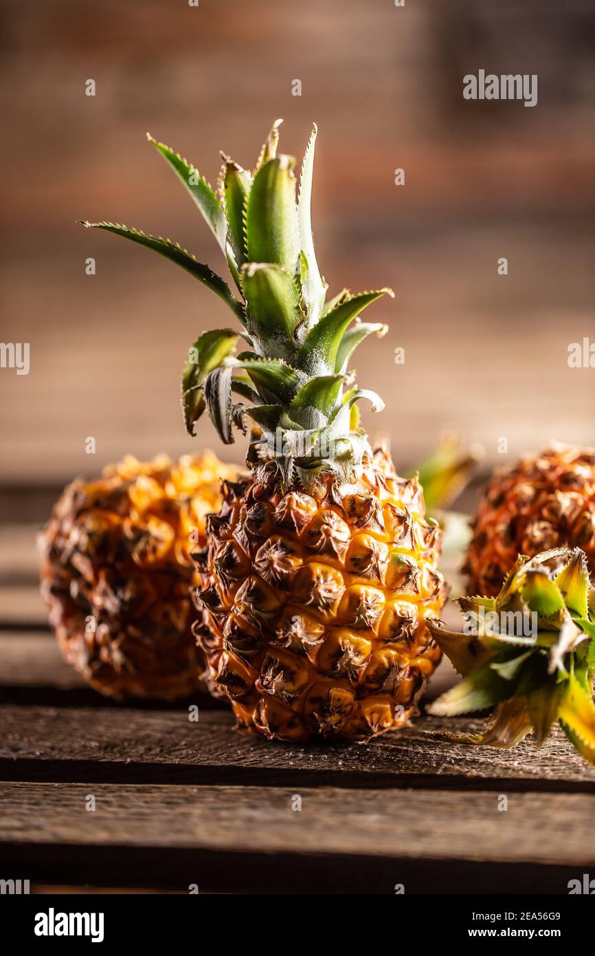 Fresh pineapples served on a vntage board. Stock Photo