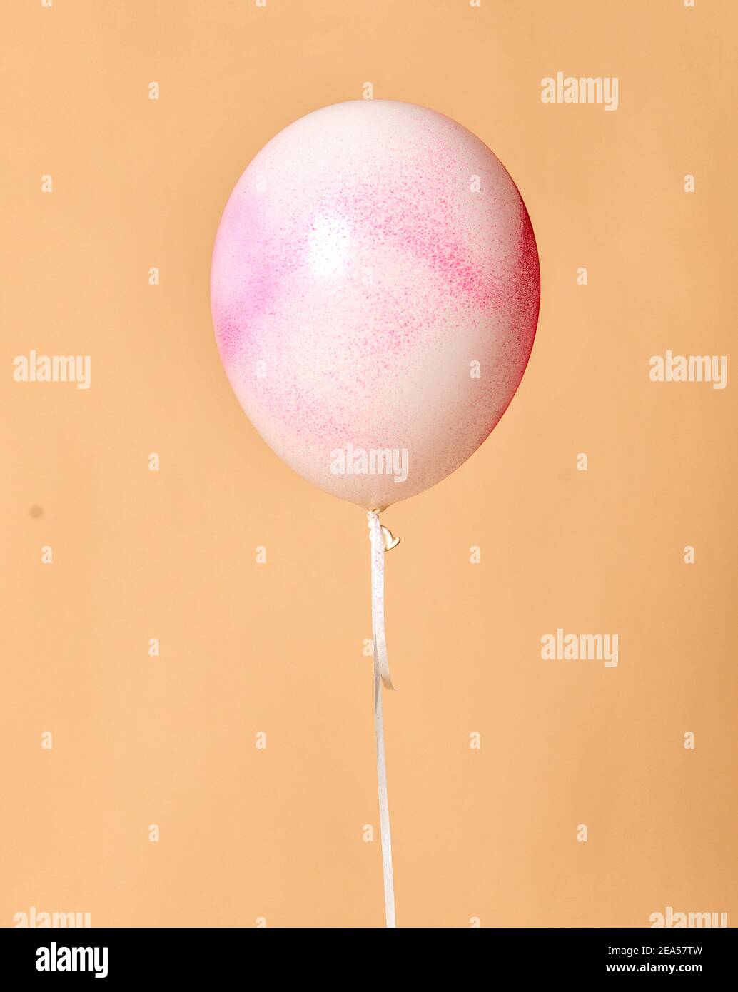 Big helium inflatable latex white balloon with pink spray paint