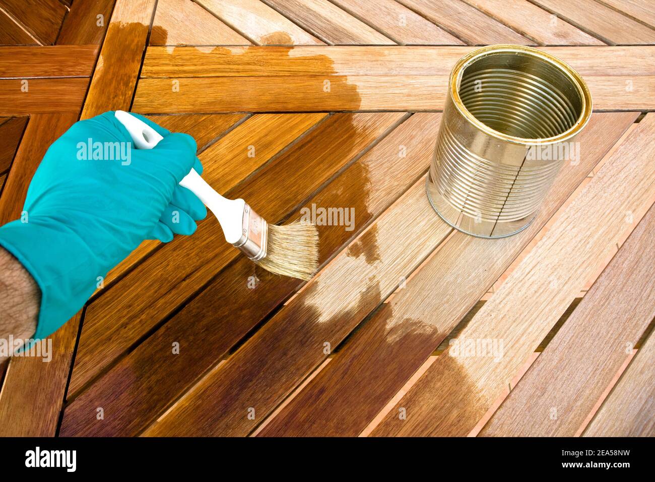 Staining wooden table. Before and after Stock Photo Alamy