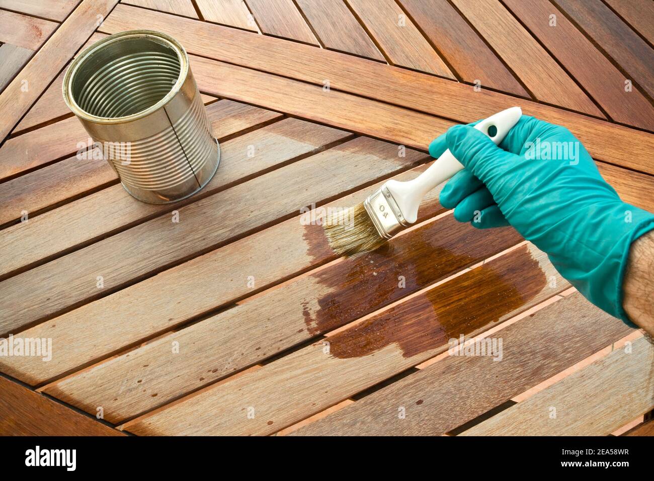 Staining wooden table. Before and after Stock Photo Alamy