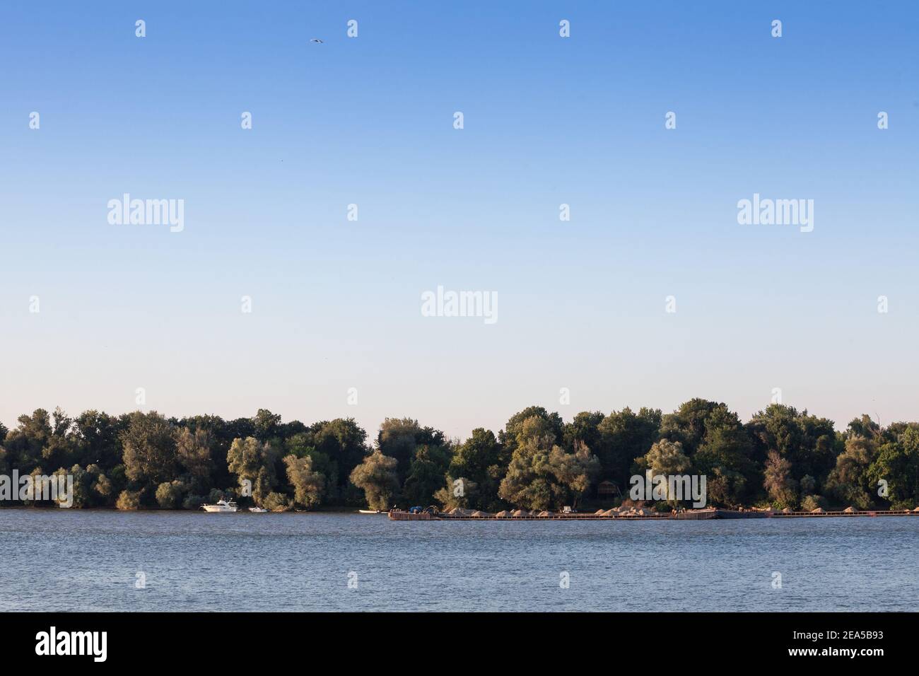 Cargo ship, a barge, cruising on the Danube river in Serbia, in belgrade, carrying construction material, coal, sand and gravel. The Danube river is a Stock Photo